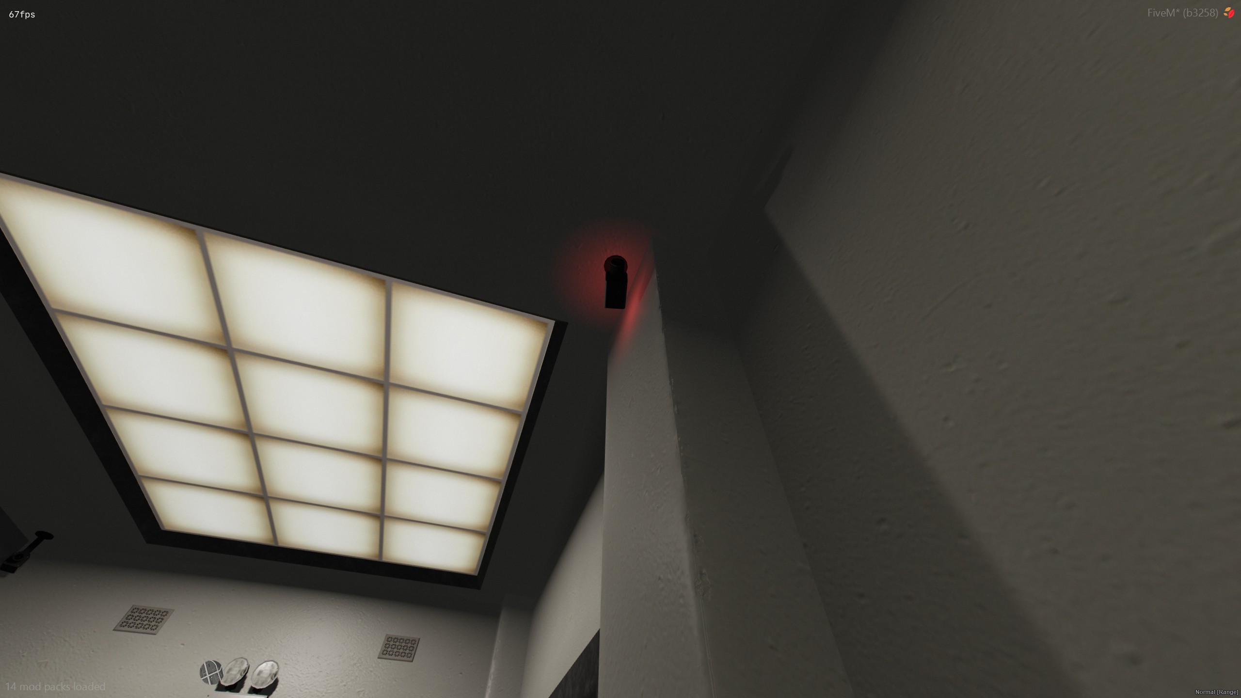 Security camera mounted in a ceiling corner with a red light