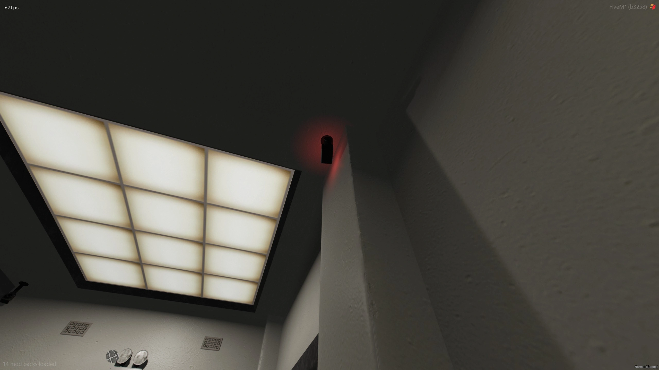 Security camera mounted in a ceiling corner with a red light